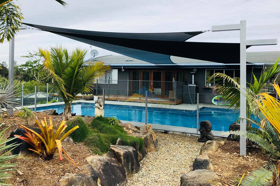 2 large shade sails over a pool